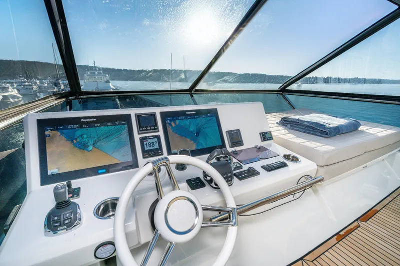 Compound Interest Yacht Photos Pics Luxurious 2018 Prestige 630 Yacht cockpit with modern navigation systems and sunlit ocean view.