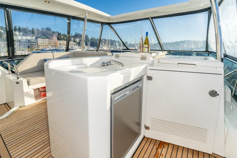 Compound Interest Yacht Photos Pics Luxurious 2018 Prestige 630 Yacht interior with kitchenette and scenic marina view.