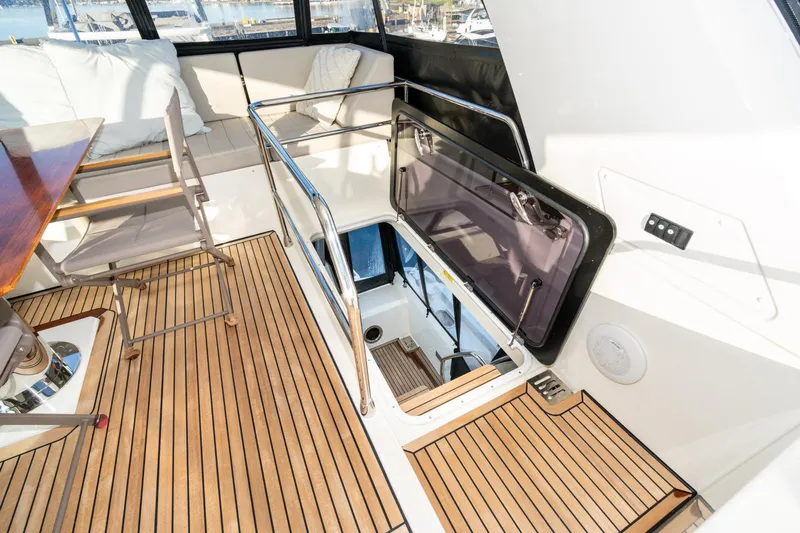 Compound Interest Yacht Photos Pics 2018 Prestige 630 Yacht interior with teak flooring and open hatch.
