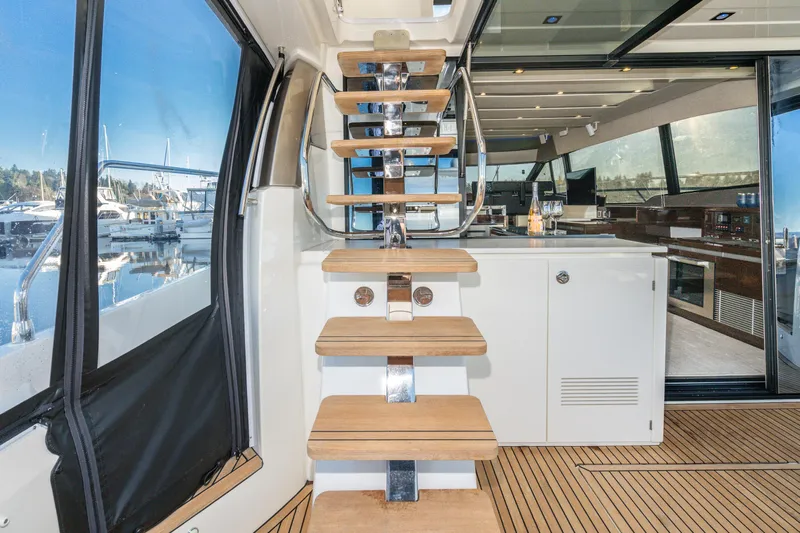 Compound Interest Yacht Photos Pics Interior view of 2018 Prestige 630 Yacht with wooden stairs and modern design.