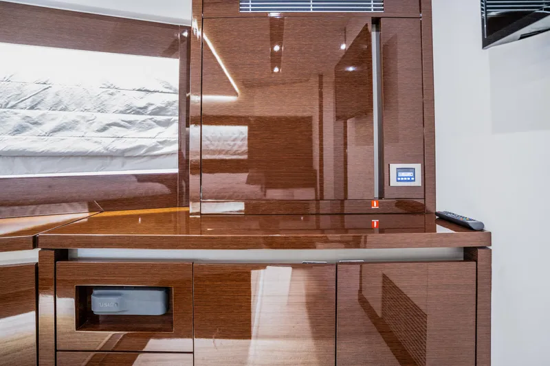 Compound Interest Yacht Photos Pics Luxurious interior of 2018 Prestige 630 Yacht with sleek wooden cabinetry.