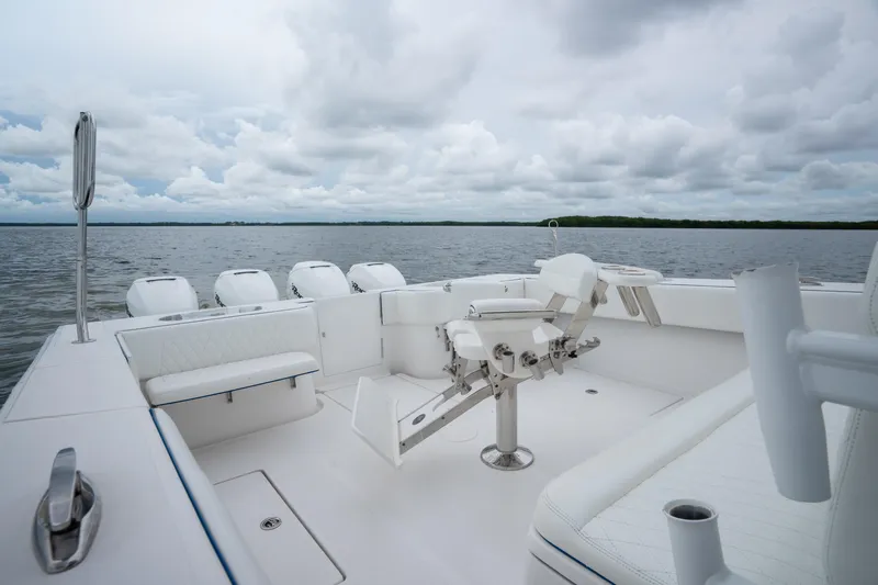  Yacht Photos Pics 2016 SeaHunter 45 boat interior with fishing chair and multiple outboard engines on a cloudy day.