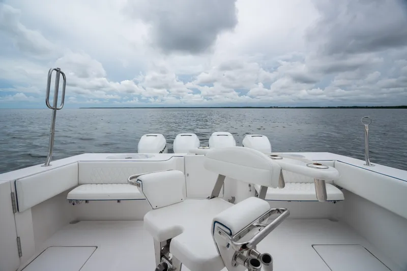  Yacht Photos Pics 2016 SeaHunter 45 boat interior with white seating, overlooking calm ocean and cloudy sky.