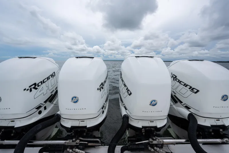  Yacht Photos Pics Four powerful outboard engines on a 2016 SeaHunter 45 boat, under a cloudy sky.