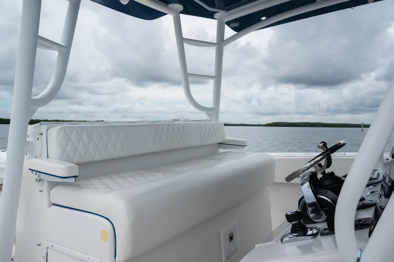  Yacht Photos Pics 2016 SeaHunter 45 boat interior with white seating and steering, under cloudy skies.