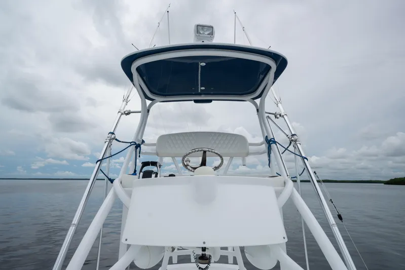  Yacht Photos Pics 2016 SeaHunter 45 boat helm with steering wheel, set against a cloudy sky and calm waters.