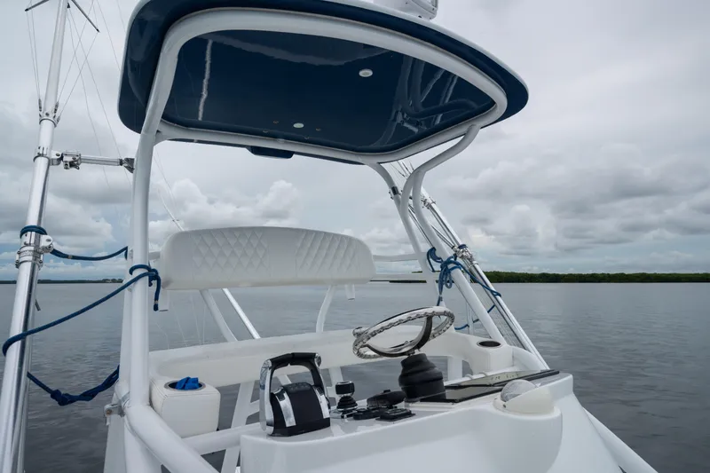  Yacht Photos Pics Helm of 2016 SeaHunter 45 boat with steering wheel and controls, on calm water.