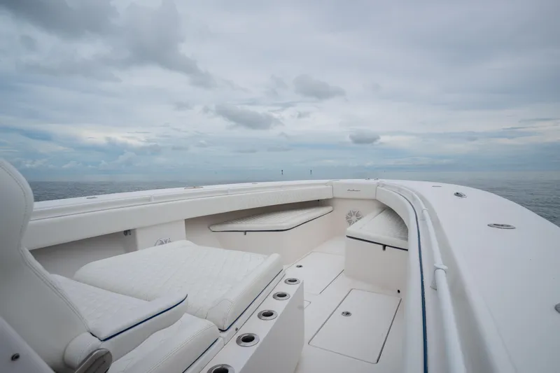  Yacht Photos Pics 2016 SeaHunter 45 boat interior with white seating, open ocean view, and cloudy sky.
