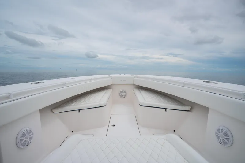  Yacht Photos Pics Bow view of 2016 SeaHunter 45 boat with white seating and ocean backdrop.