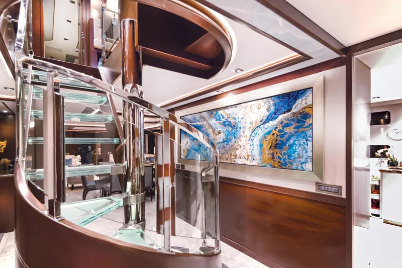  Yacht Photos Pics Luxurious interior of 2017 Nordhavn 96 yacht with spiral staircase and abstract art.