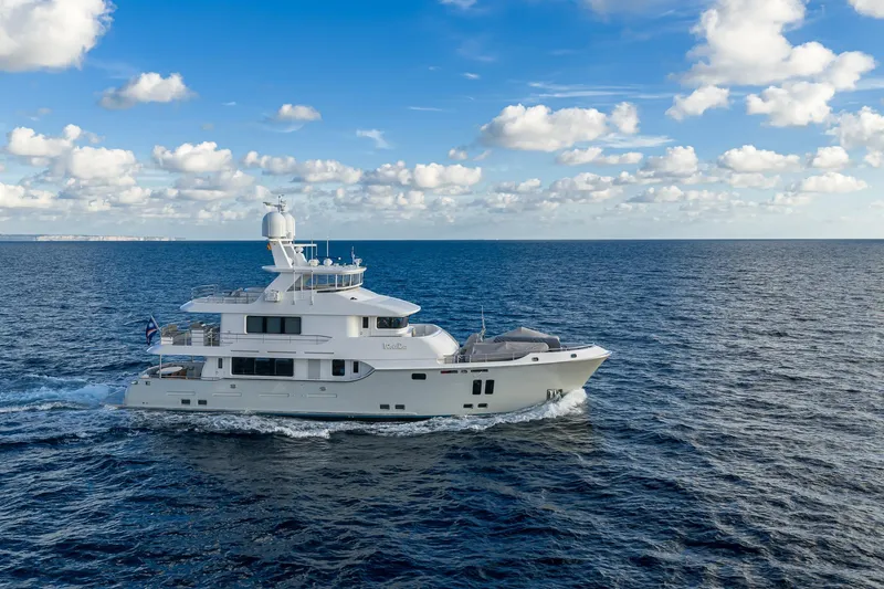  Yacht Photos Pics Luxurious 2017 Nordhavn 96 yacht cruising on open sea under blue sky.