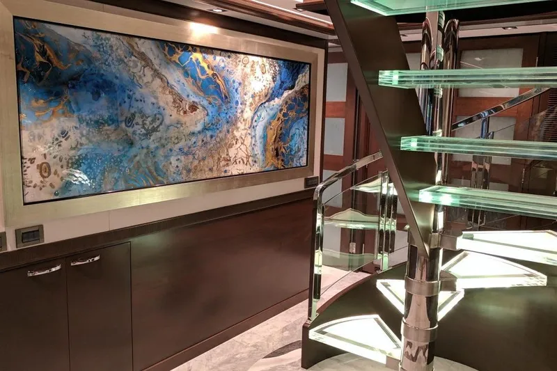  Yacht Photos Pics Luxurious interior of 2017 Nordhavn 96 yacht with modern art and glass staircase.