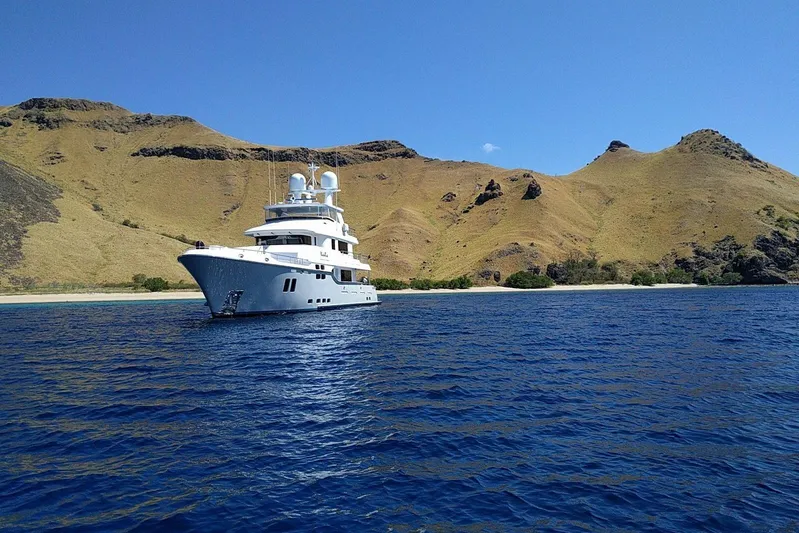  Yacht Photos Pics Luxurious 2017 Nordhavn 96 yacht cruising near scenic coastal hills.