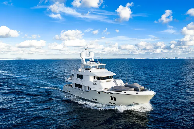  Yacht Photos Pics Luxurious 2017 Nordhavn 96 yacht cruising on open sea under blue sky.