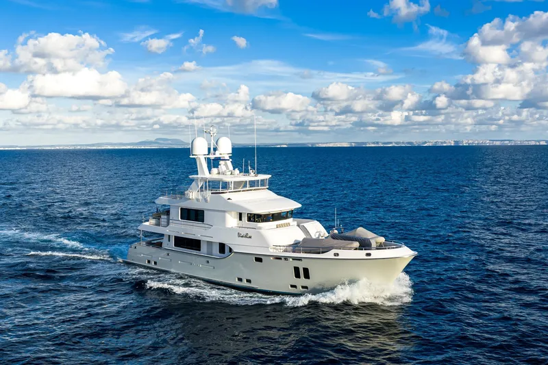  Yacht Photos Pics Luxurious 2017 Nordhavn 96 yacht cruising on open ocean under blue sky.