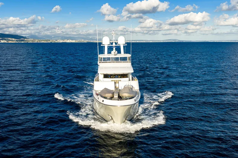  Yacht Photos Pics Luxurious 2017 Nordhavn 96 yacht cruising on open sea under blue sky.