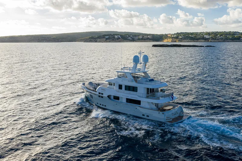  Yacht Photos Pics Luxurious 2017 Nordhavn 96 yacht cruising on open sea under a partly cloudy sky.