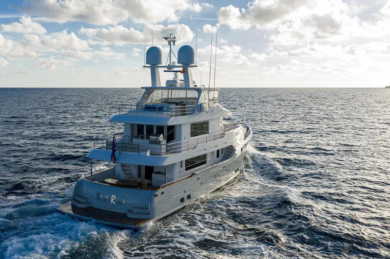  Yacht Photos Pics Luxurious 2017 Nordhavn 96 yacht cruising on open sea under a cloudy sky.