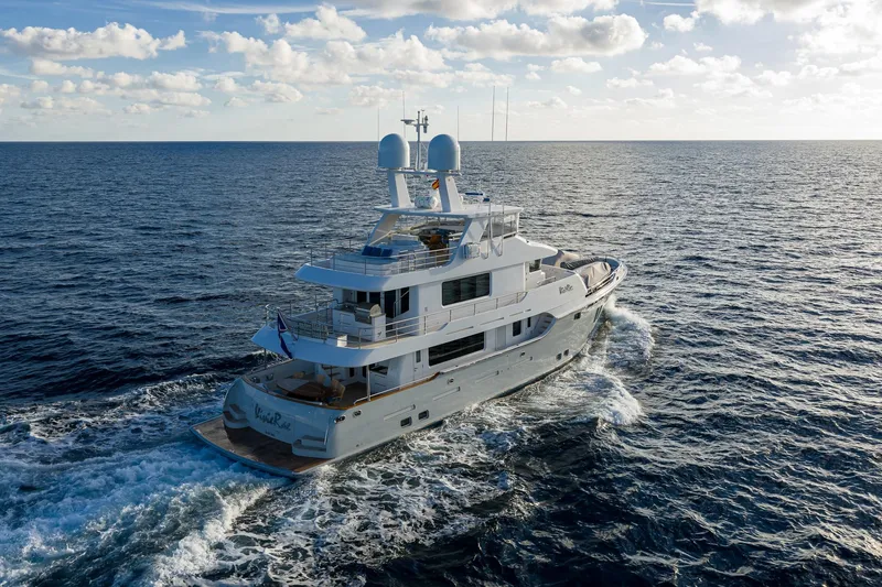  Yacht Photos Pics Luxurious 2017 Nordhavn 96 yacht cruising on open ocean under blue sky.
