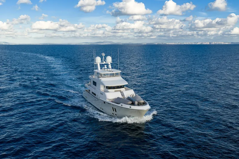  Yacht Photos Pics Luxurious 2017 Nordhavn 96 yacht cruising on open sea under blue sky.