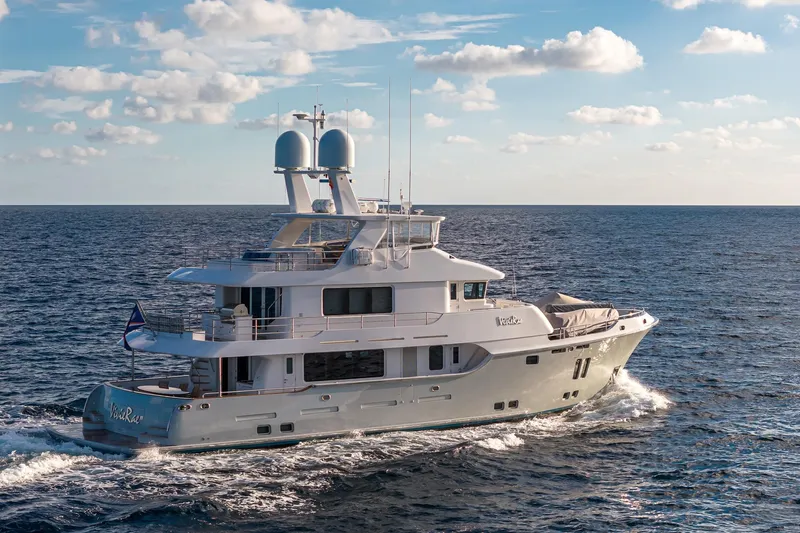  Yacht Photos Pics Luxurious 2017 Nordhavn 96 yacht cruising on open sea under blue sky.