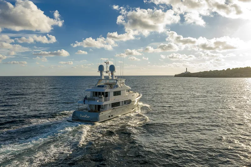  Yacht Photos Pics Luxurious 2017 Nordhavn 96 yacht cruising on open sea under a partly cloudy sky.