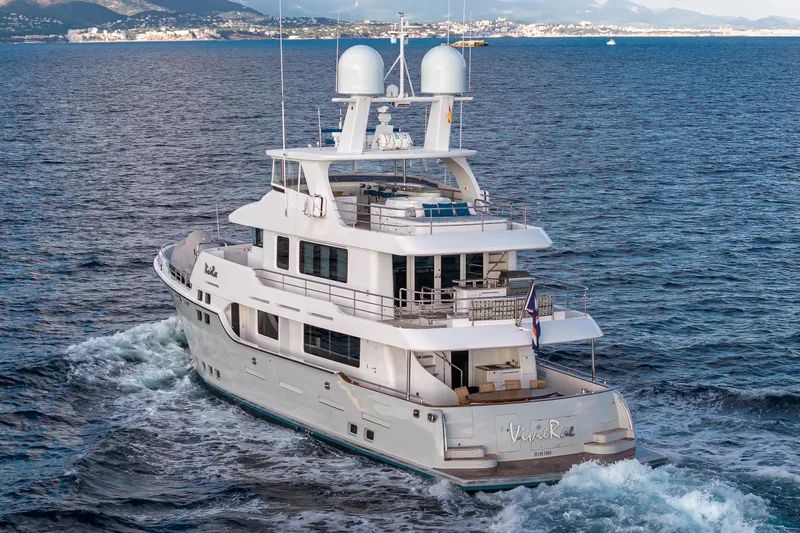  Yacht Photos Pics Luxurious 2017 Nordhavn 96 yacht cruising on open sea with scenic coastal backdrop.