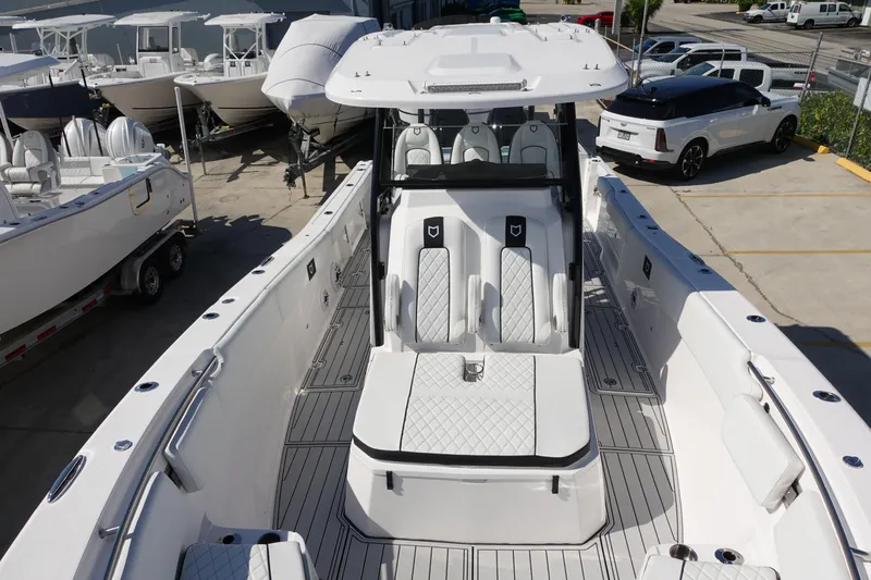  Yacht Photos Pics 2025 Sea Fox 328 Commander boat with sleek seating and modern design in a marina setting.