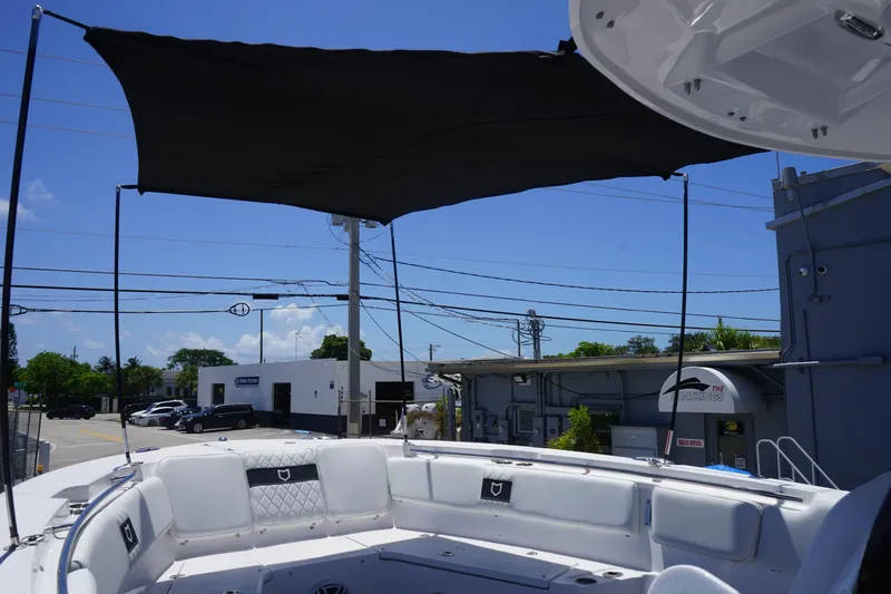  Yacht Photos Pics 2025 Sea Fox 328 Commander boat with sunshade and seating, parked outdoors.