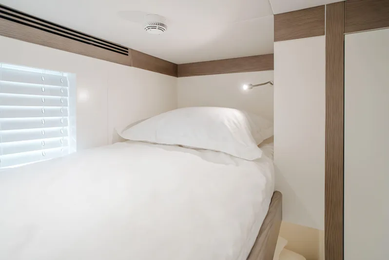 Bering 65 Explorer Yacht Yacht Photos Pics Cozy cabin interior of 2026 Bering 65 yacht with a neatly made bed.