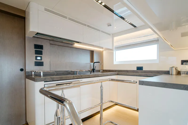Bering 65 Explorer Yacht Yacht Photos Pics Modern kitchen interior on 2026 Bering 65 yacht, featuring sleek cabinetry and stainless steel accents.