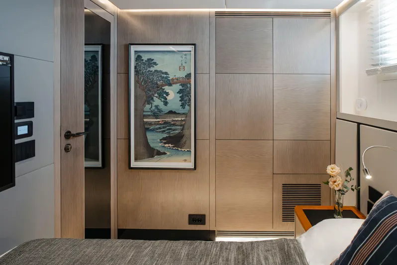 Bering 65 Explorer Yacht Yacht Photos Pics Modern bedroom interior on 2026 Bering 65 yacht, featuring elegant wood paneling and framed artwork.