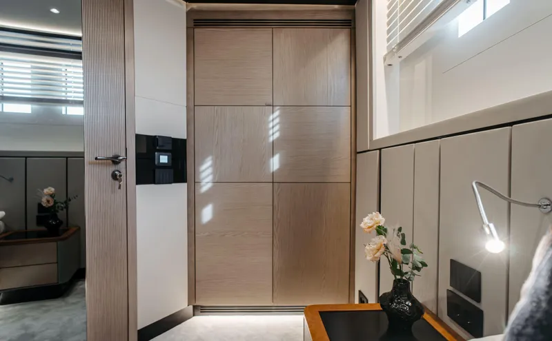 Bering 65 Explorer Yacht Yacht Photos Pics Luxurious interior of 2026 Bering 65 yacht with modern wood paneling and elegant decor.