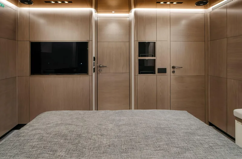 Bering 65 Explorer Yacht Yacht Photos Pics Modern interior of 2026 Bering 65 yacht cabin with wood paneling and TV.