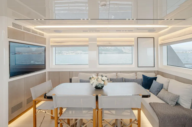 Bering 65 Explorer Yacht Yacht Photos Pics Luxurious interior of 2026 Bering 65 yacht with elegant dining area and sea view.