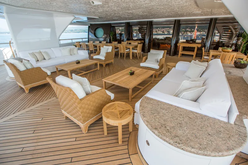 Pelorus Yacht Photos Pics Luxurious Lurssen Custom 2003 yacht deck with elegant seating and wooden flooring.
