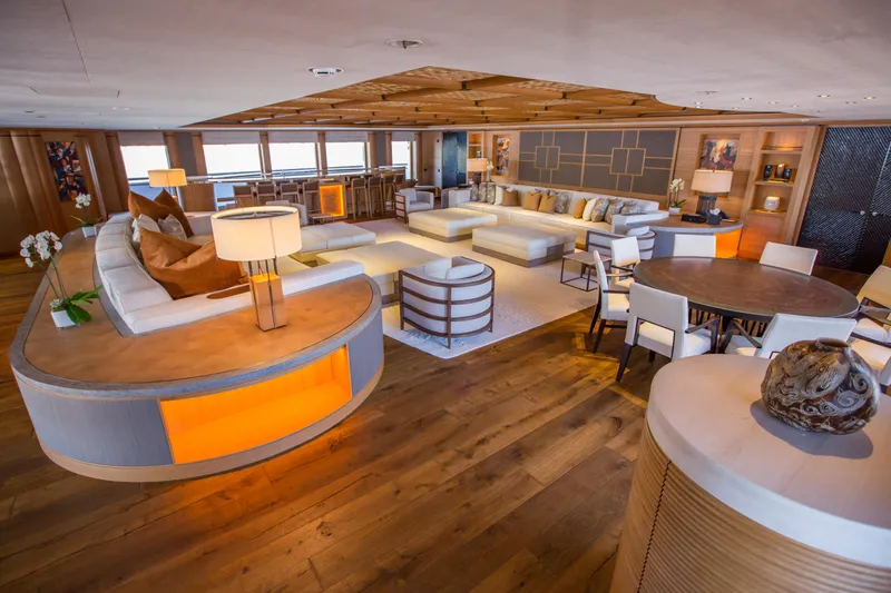 Pelorus Yacht Photos Pics Luxurious yacht interior with modern furnishings, warm lighting, and wooden flooring, Lurssen Custom 2003.