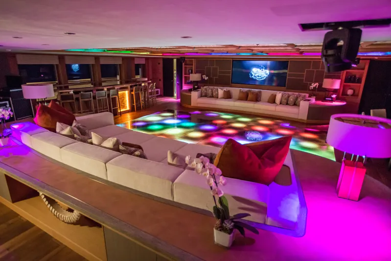 Pelorus Yacht Photos Pics Luxurious yacht interior with vibrant lighting, spacious seating, and modern decor, Lurssen Custom 2003.