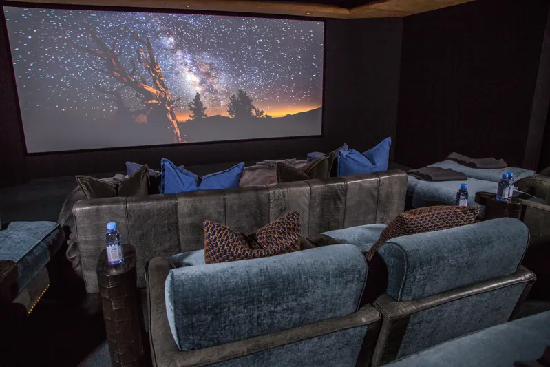 Pelorus Yacht Photos Pics Luxurious yacht cinema room with plush seating, starry night screen, Lurssen Custom 2003.