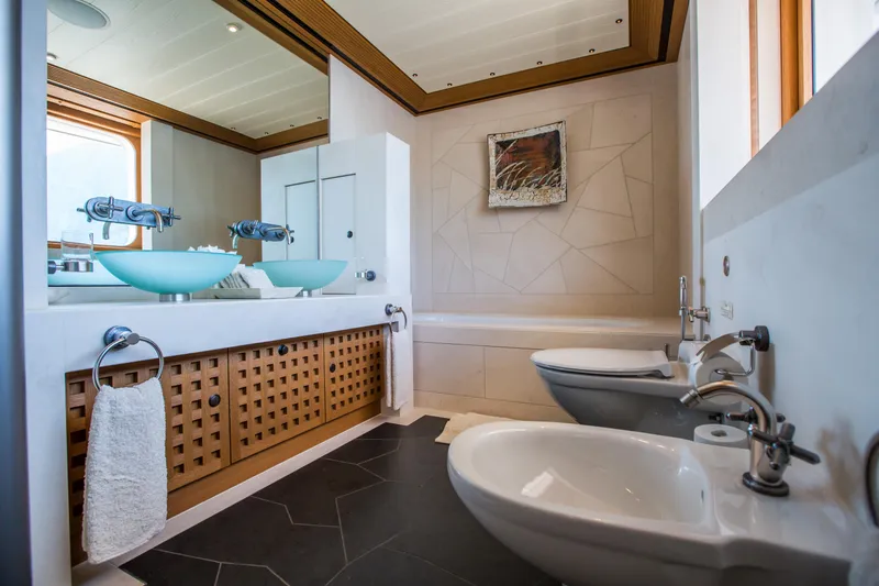 Pelorus Yacht Photos Pics Luxurious yacht bathroom with modern fixtures, glass sinks, and elegant design, Lurssen Custom 2003.