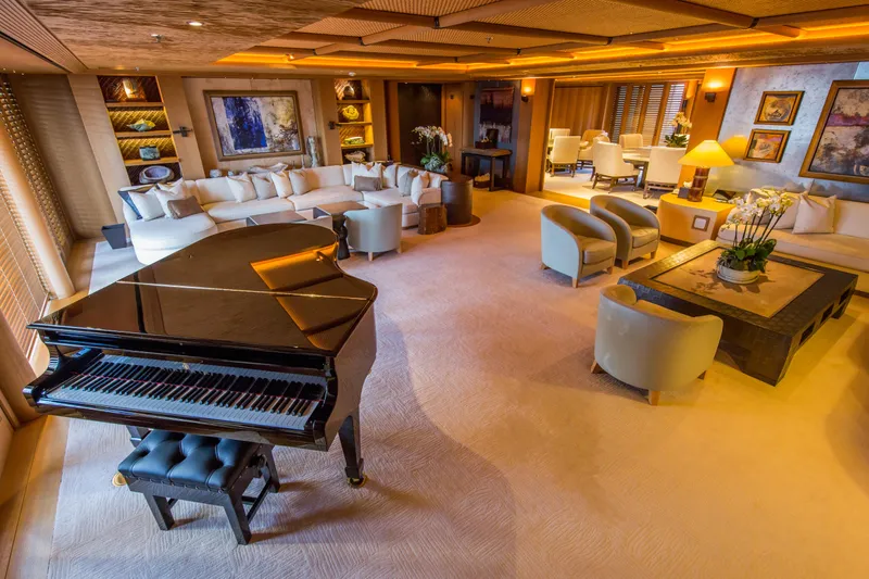 Pelorus Yacht Photos Pics Luxurious yacht interior with grand piano, elegant seating, and warm lighting, Lurssen Custom 2003 model.