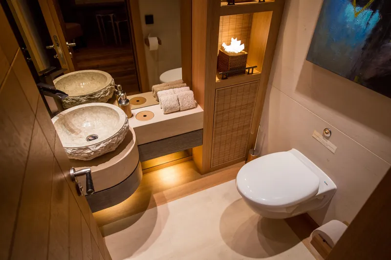 Pelorus Yacht Photos Pics Luxurious yacht bathroom with stone sinks, modern fixtures, and warm lighting, Lurssen Custom 2003.