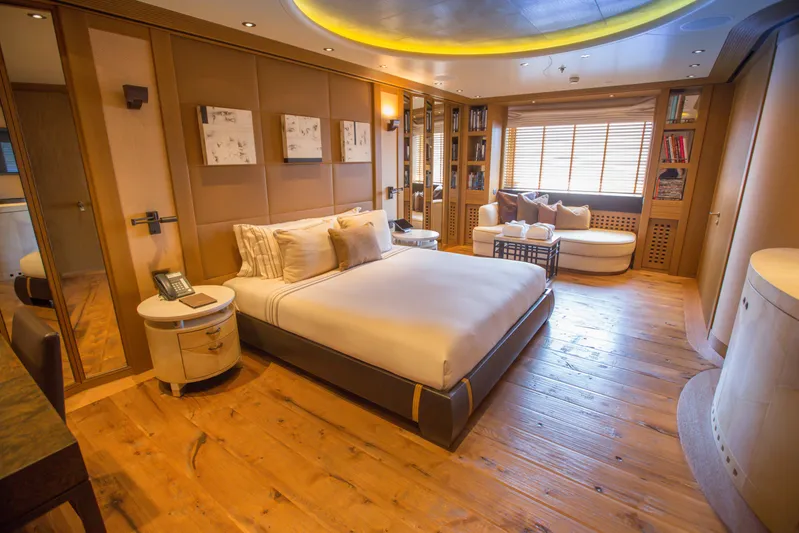 Pelorus Yacht Photos Pics Luxurious bedroom interior on 2003 Lurssen Custom yacht with elegant wood flooring and modern decor.