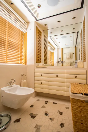 Pelorus Yacht Photos Pics Luxurious yacht bathroom with modern fixtures, wooden blinds, and elegant cabinetry, Lurssen Custom 2003.