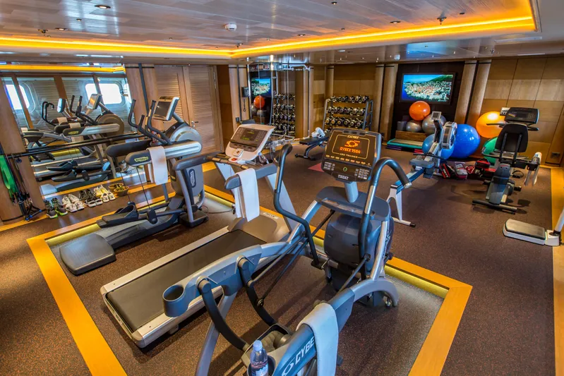 Pelorus Yacht Photos Pics Luxurious yacht gym with modern equipment, featuring treadmills and weights, on a 2003 Lurssen Custom.