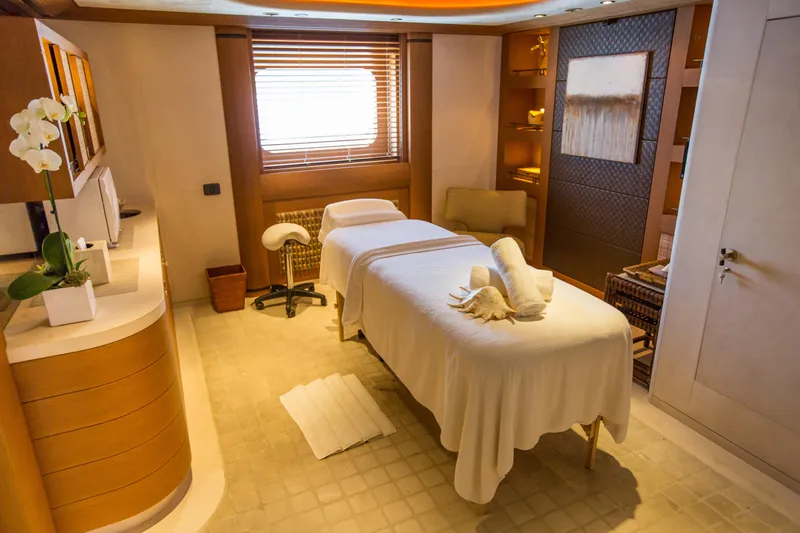 Pelorus Yacht Photos Pics Luxurious spa room on a 2003 Lurssen Custom yacht, featuring a massage table and elegant decor.