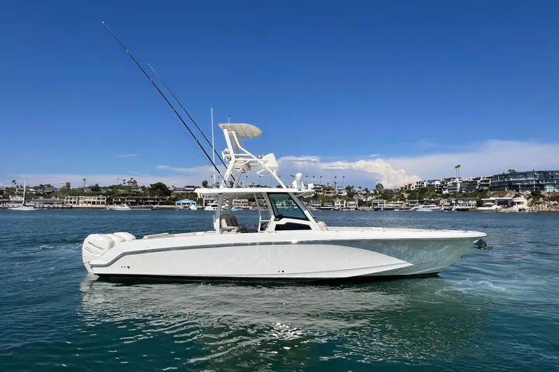 M22 Yacht Photos Pics 2019 Boston Whaler 380 Outrage boat on calm water, clear sky background.