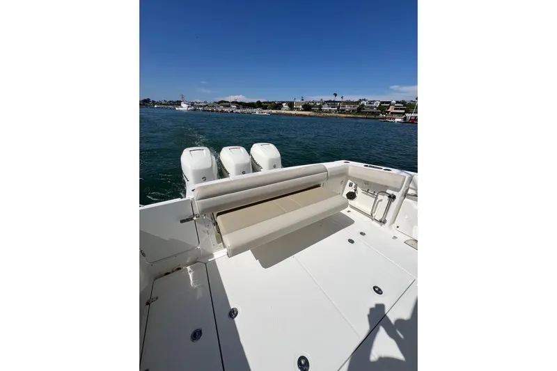 M22 Yacht Photos Pics 2019 Boston Whaler 380 Outrage boat with triple engines on calm water.
