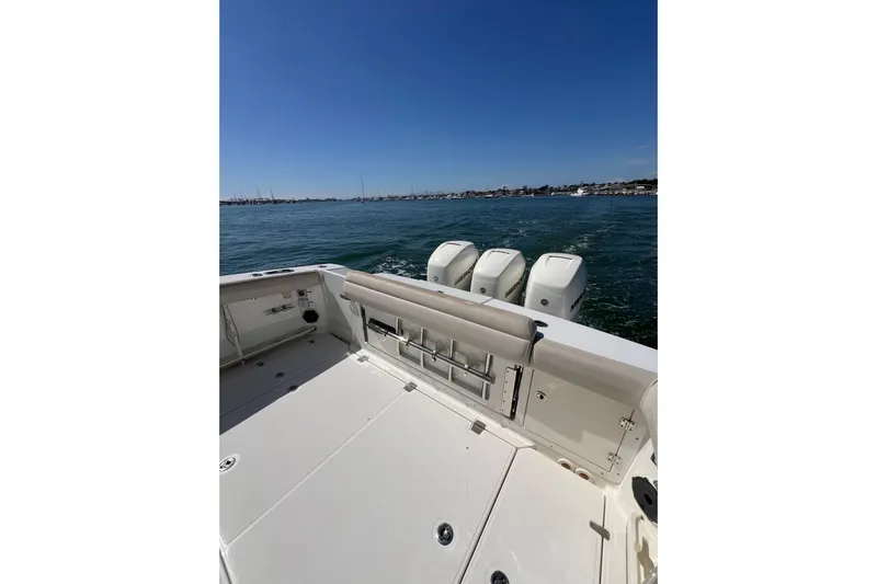 M22 Yacht Photos Pics 2019 Boston Whaler 380 Outrage boat on water, showcasing spacious deck and powerful engines.