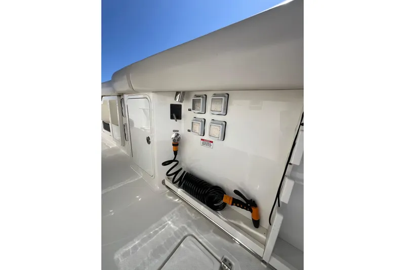 M22 Yacht Photos Pics 2019 Boston Whaler 380 Outrage deck with utility panel and coiled hose.